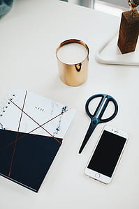 black scissors beside gold iPhone 6 thumbnail
