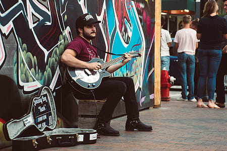 Man Playing Black Cutaway Guitar thumbnail