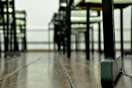 black-and-white wooden chairs and tables on brown wooden floor thumbnail