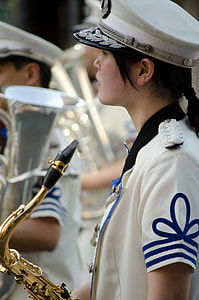 selective focus photography of woman holding saxophone thumbnail