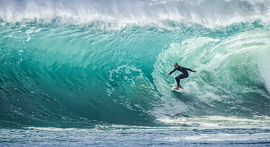 surfer under the ocean wave thumbnail