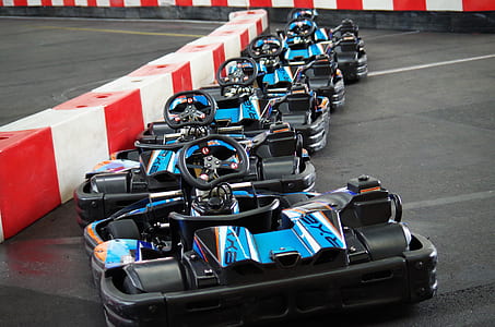 black and blue racing cars on grey road thumbnail