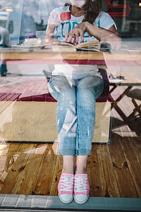 Woman reading book at coffee shop thumbnail