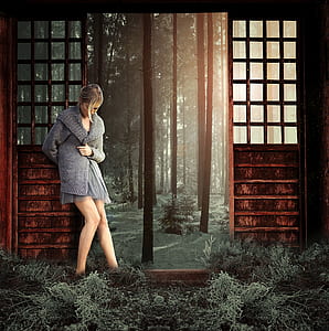 woman wearing gray fur coat leaning on wall thumbnail