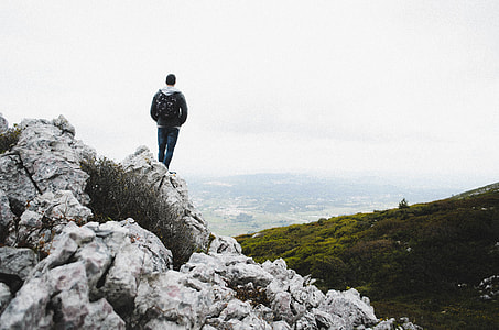 man standing on mountain edge thumbnail