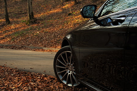 close-up photo of black Mercedes-Benz vehicle on road near trees at daytime thumbnail