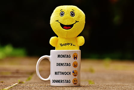 yellow dinosaur plush on in white ceramic mug thumbnail