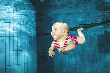 Baby swimming under water in pool thumbnail
