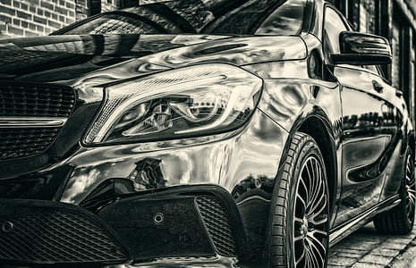 parked metallic black sedan thumbnail
