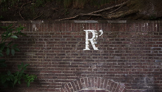 red concrete brick wall with painted letter R thumbnail