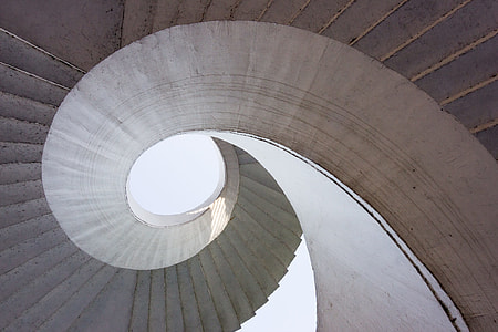 low-angle photography of spiral conrete stairs thumbnail