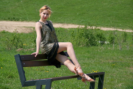 woman sitting on backrest of bench thumbnail