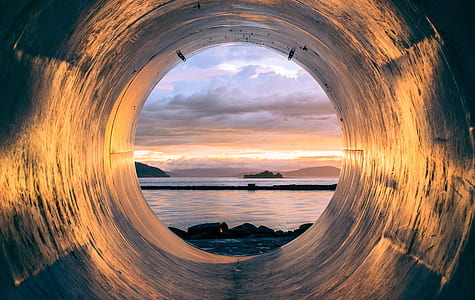 inside the hole photo of body of water during sunset thumbnail