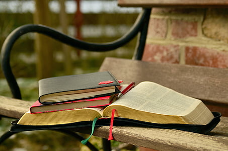 assorted books on brown wooden bench with black steel frame thumbnail