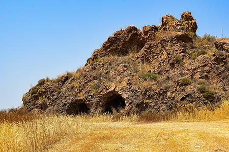wide angle photo of brown mountain under blue sky thumbnail