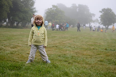 boy standing on grass field thumbnail