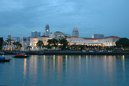boat in body of water surrounded with city building during night time thumbnail