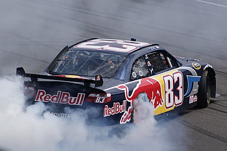drifting white and red Toyota race car during daytime thumbnail