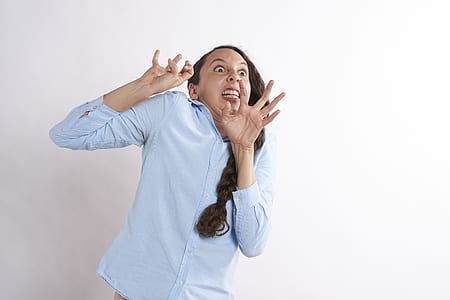 woman standing near white wall thumbnail
