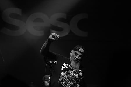 gray scale photo of man with long sleeved shirt and cap thumbnail
