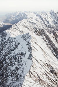 brown mountain covered by snow during daytime thumbnail