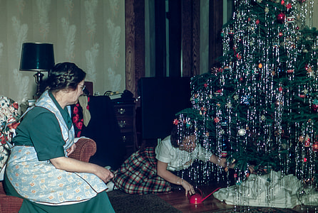 woman arranging christmas tree thumbnail