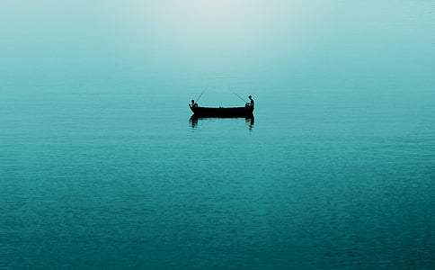 two person on brown canoe in body of water at daytime thumbnail