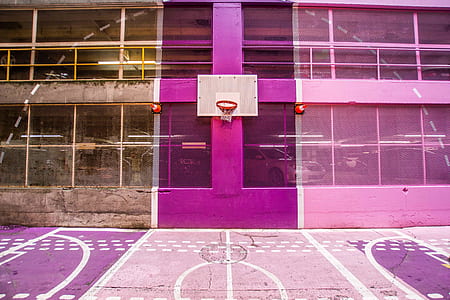 white and brown portable basketball hoop on pink painted wall thumbnail