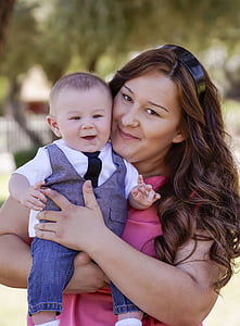 woman carrying baby boy thumbnail