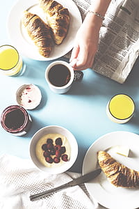bread on plate near mug on table thumbnail
