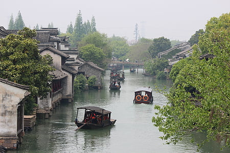 brown boats cruising on river thumbnail