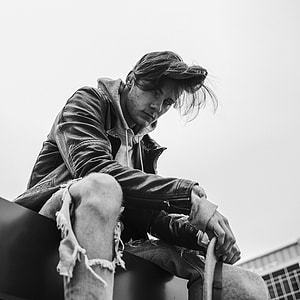 grayscale photography of man wearing jacket thumbnail