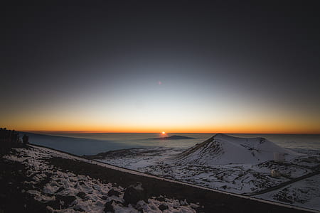 photograph of mountain and sea during golden hour thumbnail