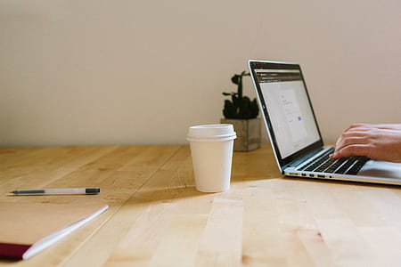 person using laptop beside cup thumbnail