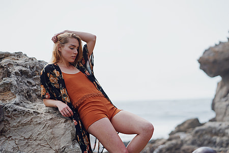 woman leaning on rock outdoor thumbnail