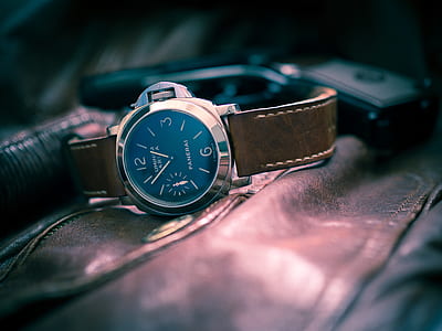 round black analog watch with leather strap thumbnail
