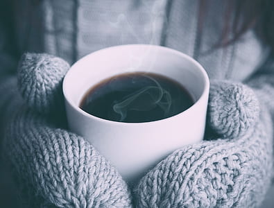 person holding ceramic mug with coffe thumbnail