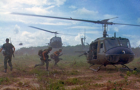 soldier on field riding on helicopter thumbnail