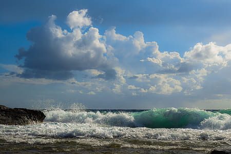 white cumulus clouds over seashore thumbnail