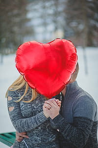 Couple Holding Hands With Red Heart Balloon thumbnail