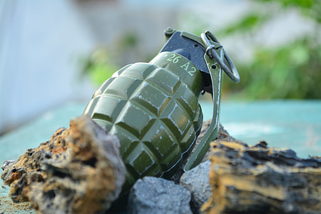 green frag grenade on brown rock thumbnail