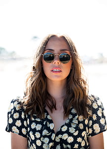 woman in black and white floral top wearing sunglasses thumbnail