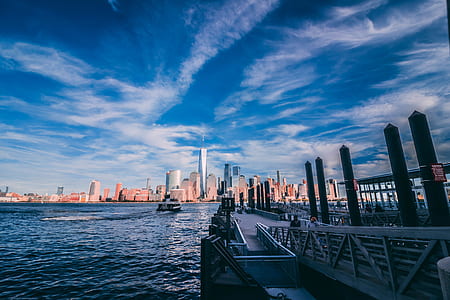 photography of high-rise building near body of water thumbnail