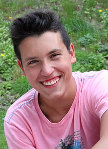 man wearing pink shirt smiling thumbnail