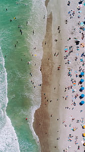 aerial view of people near beach during daytime thumbnail