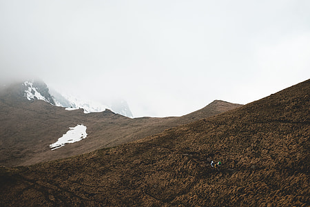 brown mountains during foggy daytime thumbnail