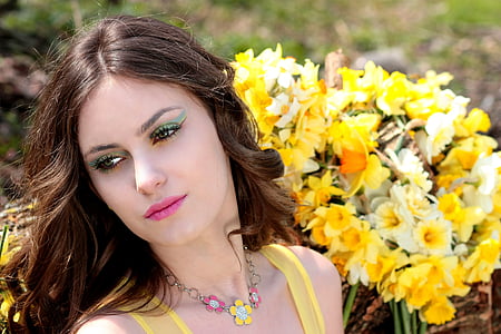 woman wears yellow tank top near yellow flowers thumbnail