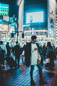 man standing in the middle of street texting thumbnail