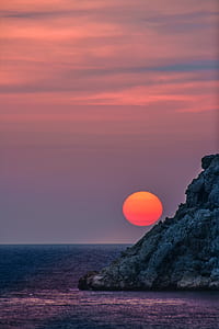mountain beside water during golden hou thumbnail