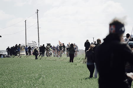 several people standing on grass field thumbnail
